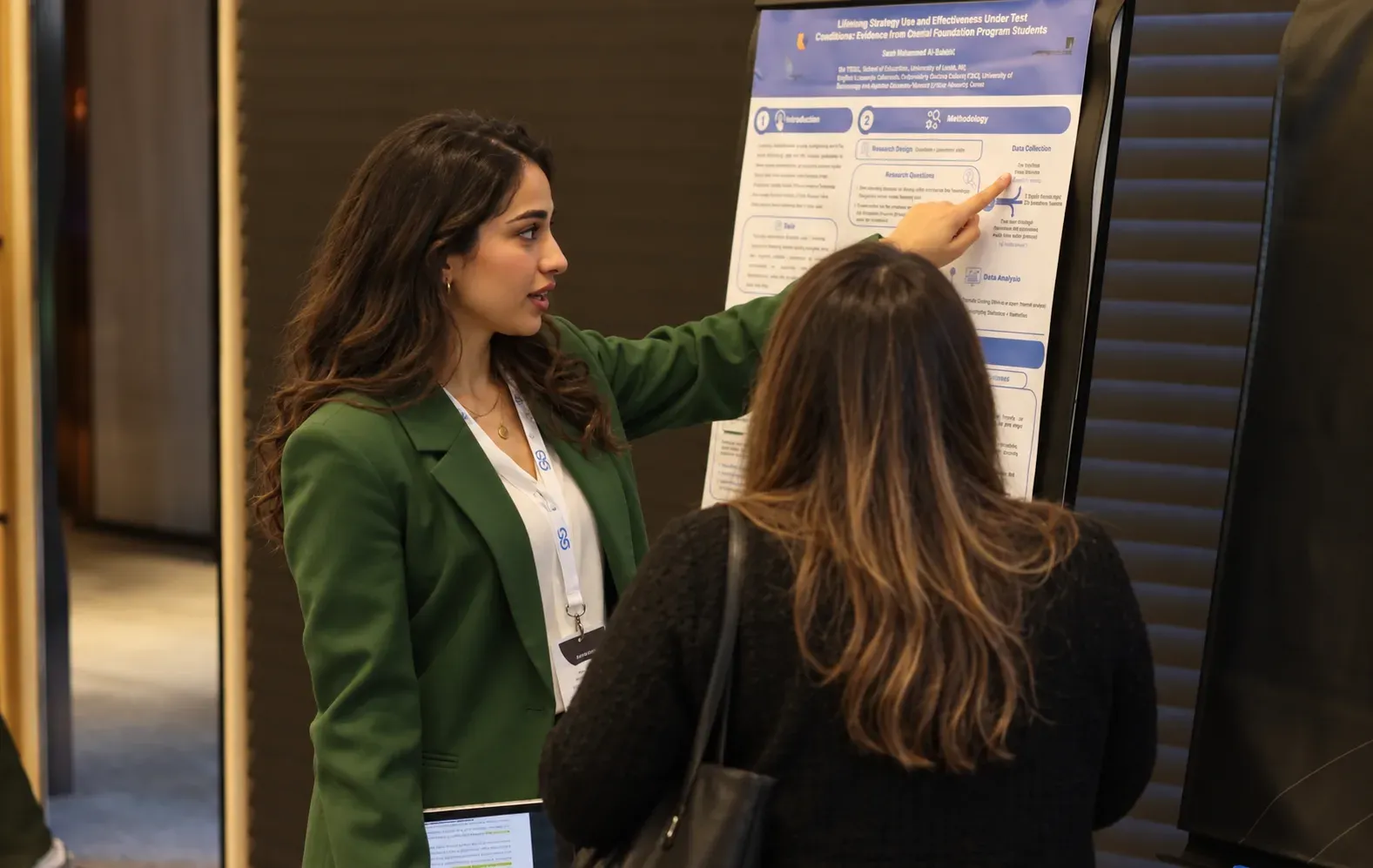Researcher presenting a poster to a participant