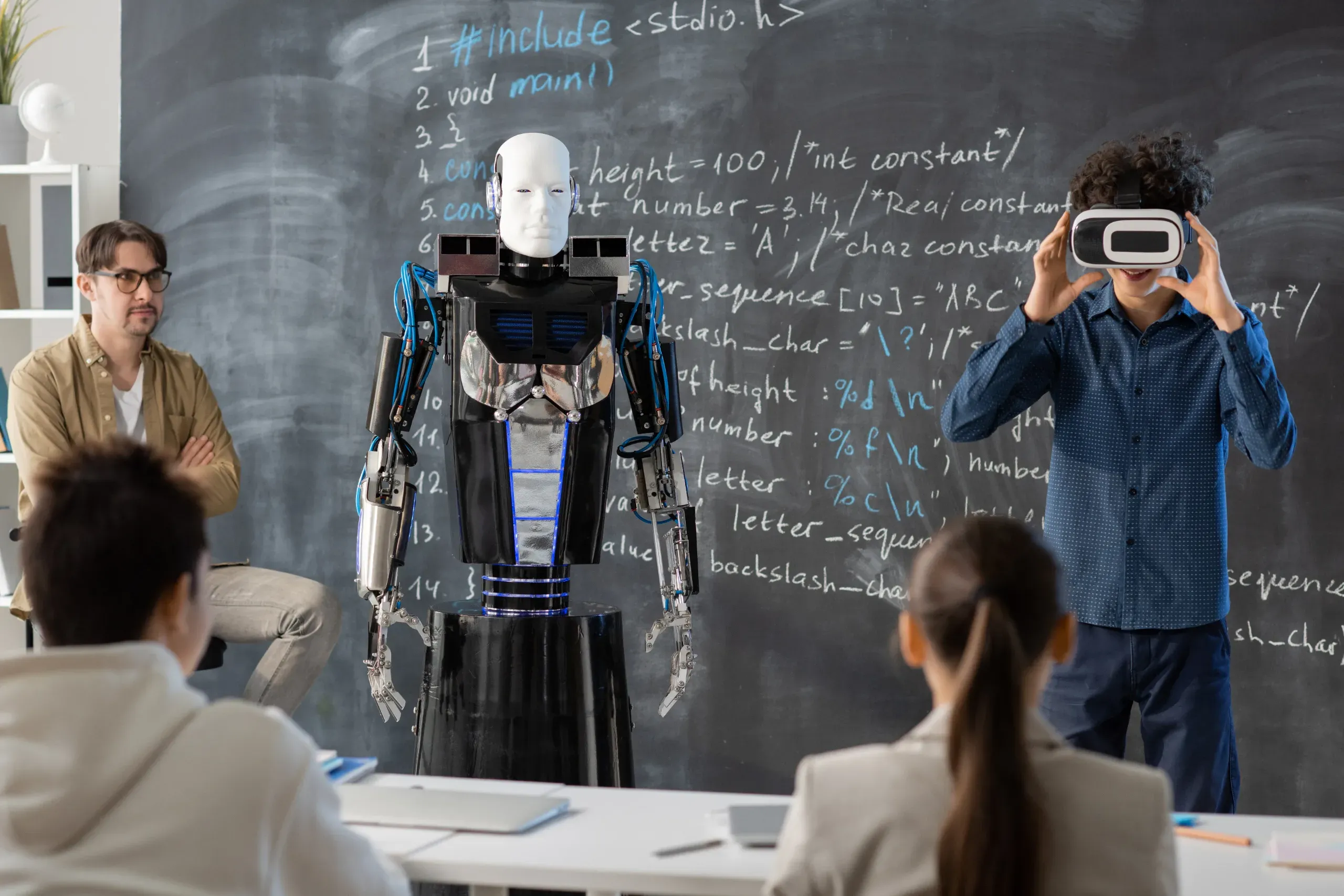 Students learning with a robot and VR headset
