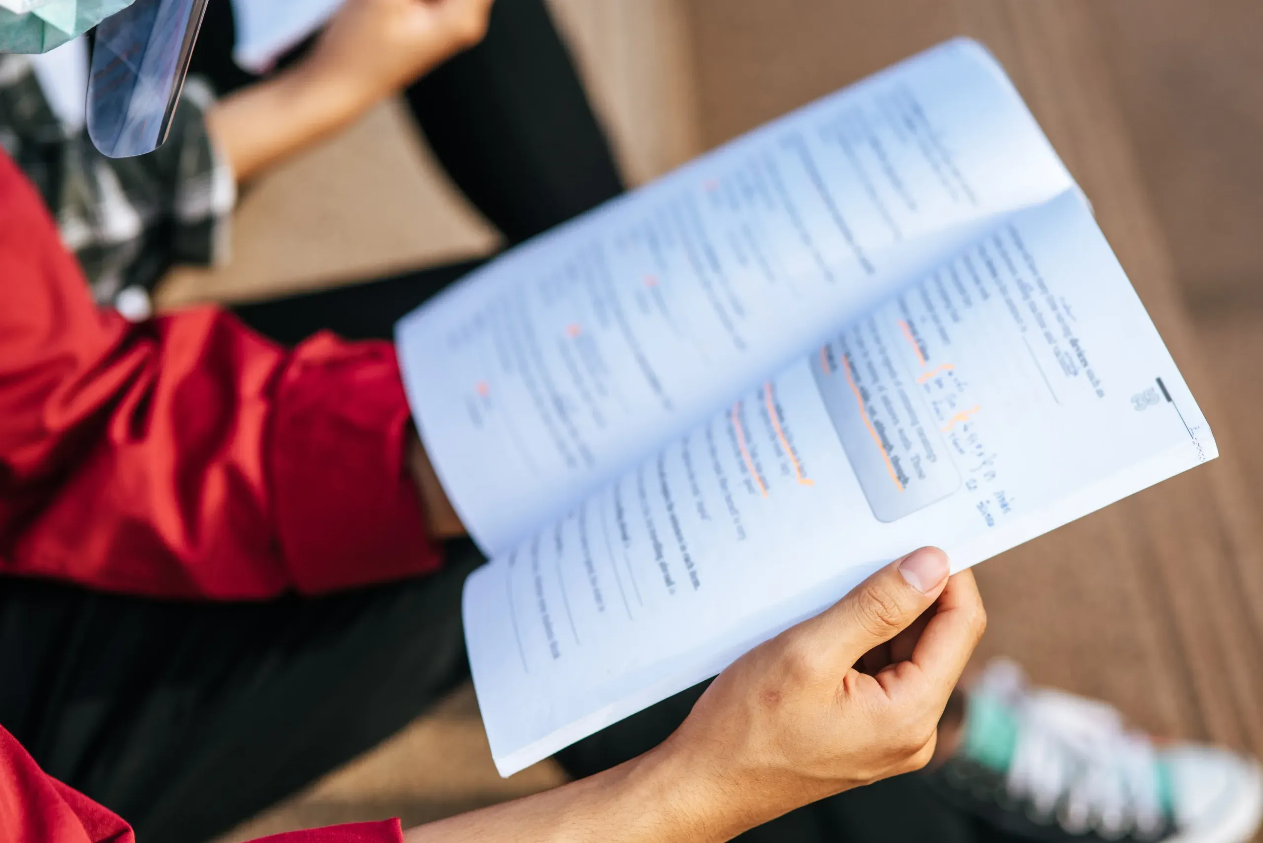 Adult learner reading an open textbook